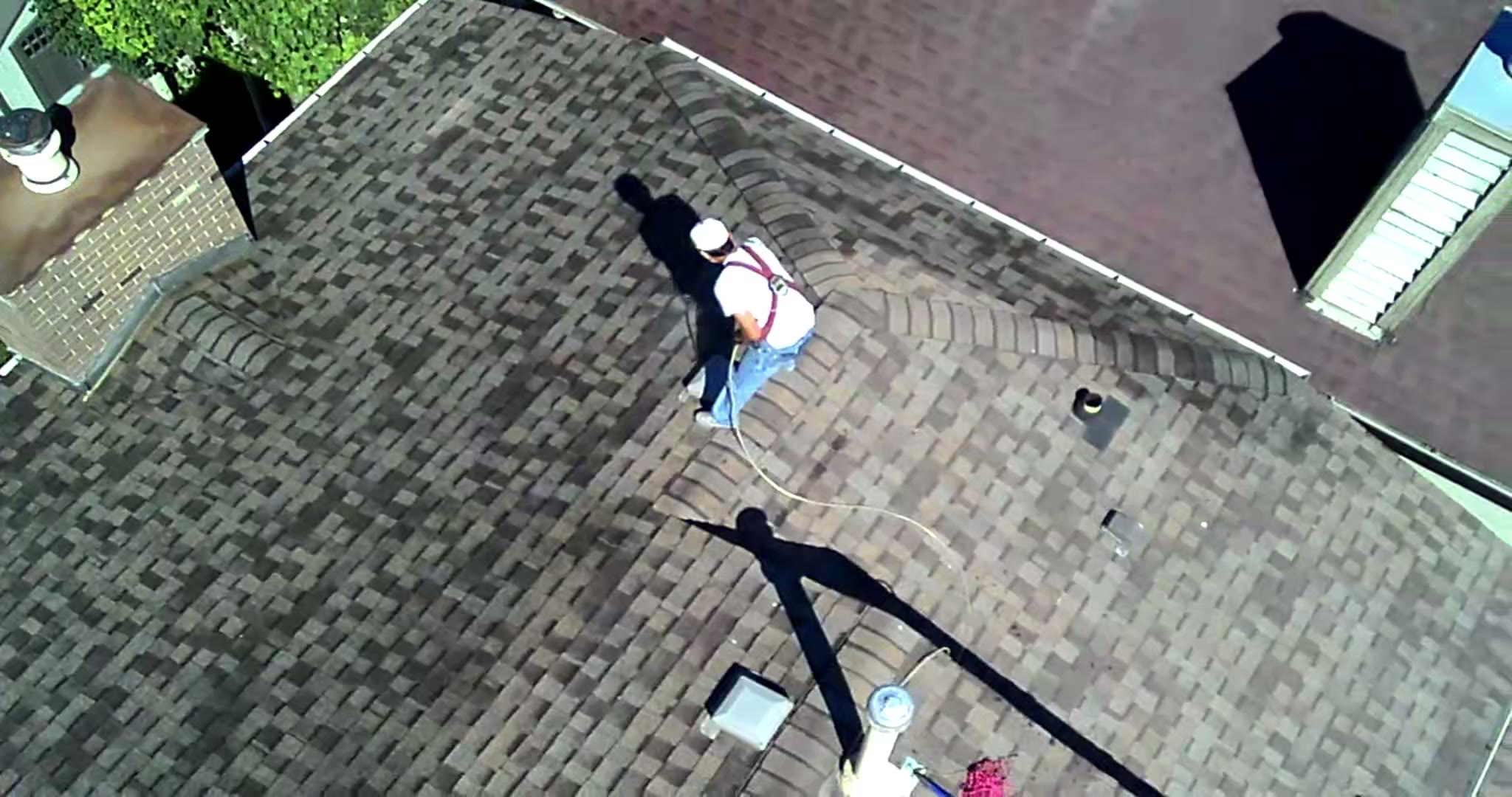 Top-down drone view of the Nano Shield crew working on a Calgary roof