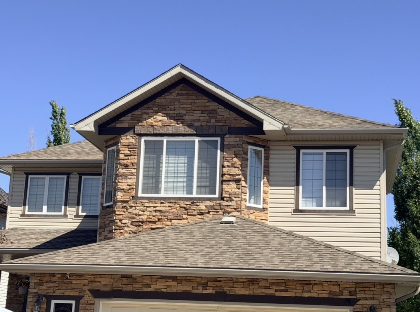 Asphalt shingle roof partway through a Nano Shield job in Calgary