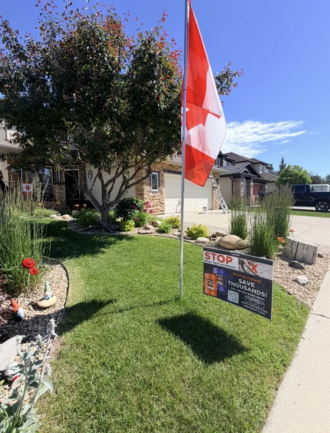 Ladder and GoNano NuRoof yard sign at a Nano Shield job in a Calgary neighborhood
